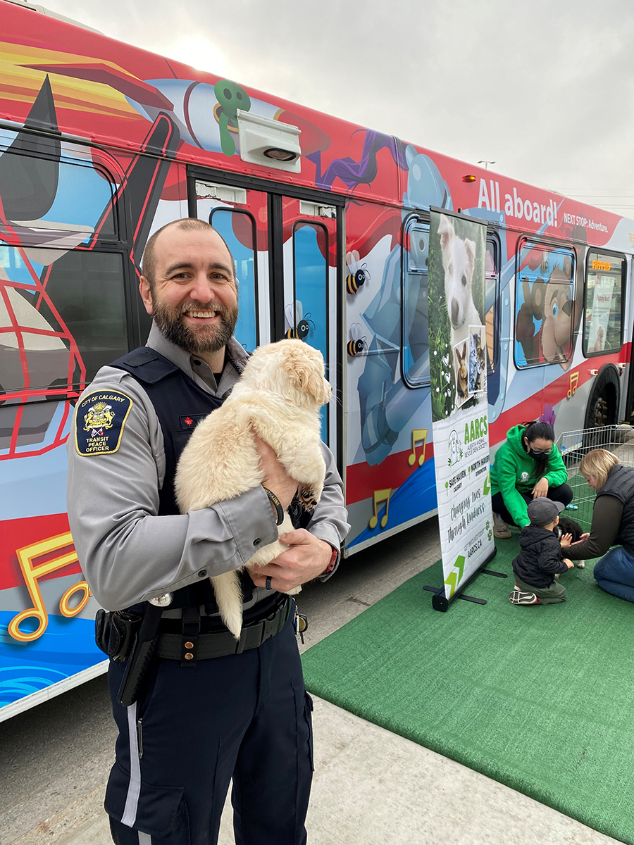Officer holding a puppy